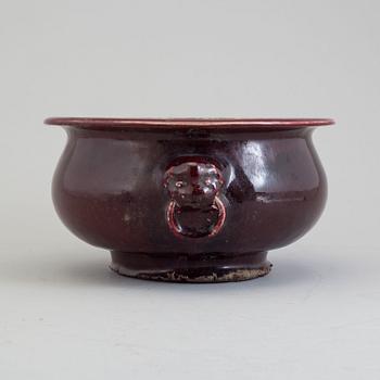 A large red glazed tripod censer, 20th century.