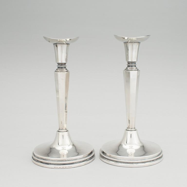 A pair of silver candle stick holders by Erik Löfman, MGAB, Uppsala, 1976.