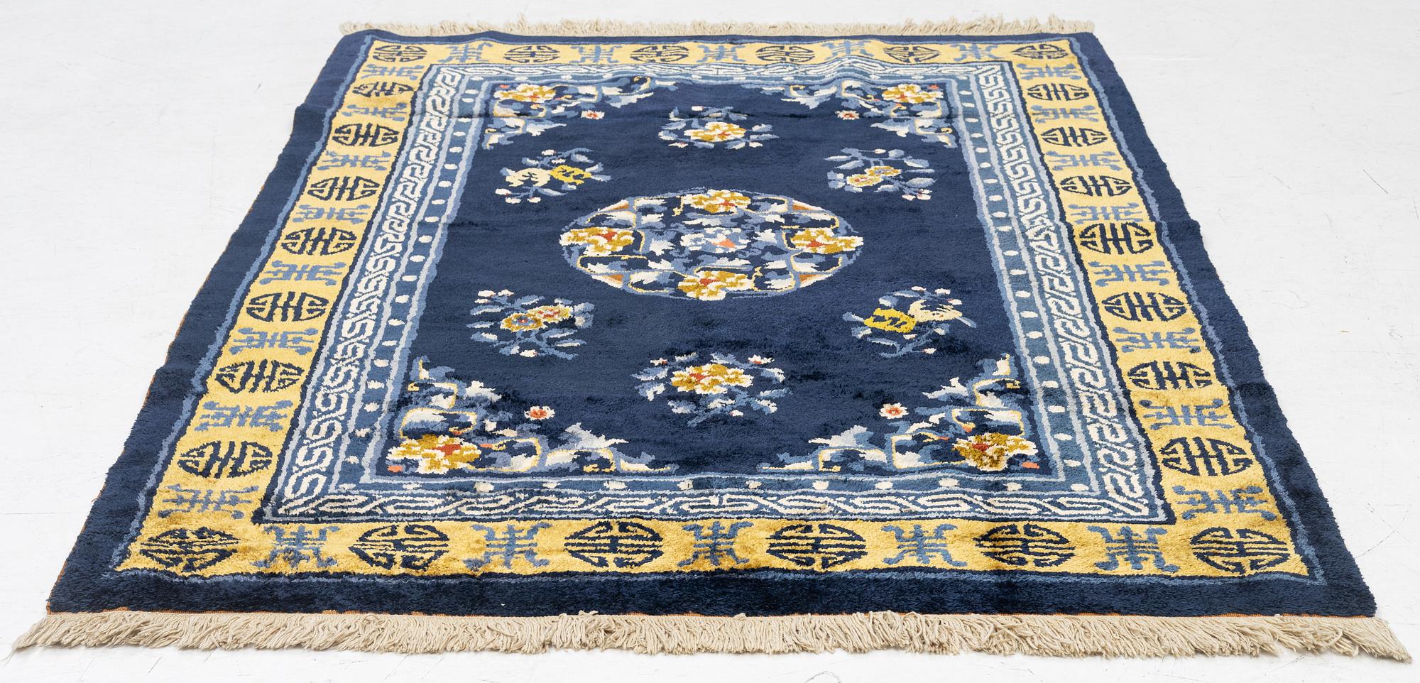 A semi-antique silk Chinaese 'Antique finish' rug, c. 175 x 122 cm.