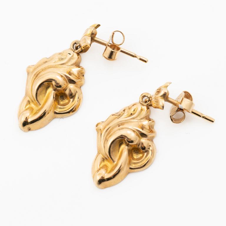 A pair of 18K gold earrings.