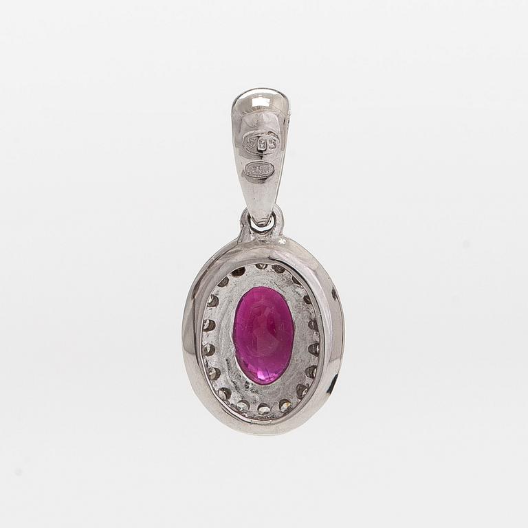 A 14K white gold pendant, with an oval faceted ruby and diamonds.