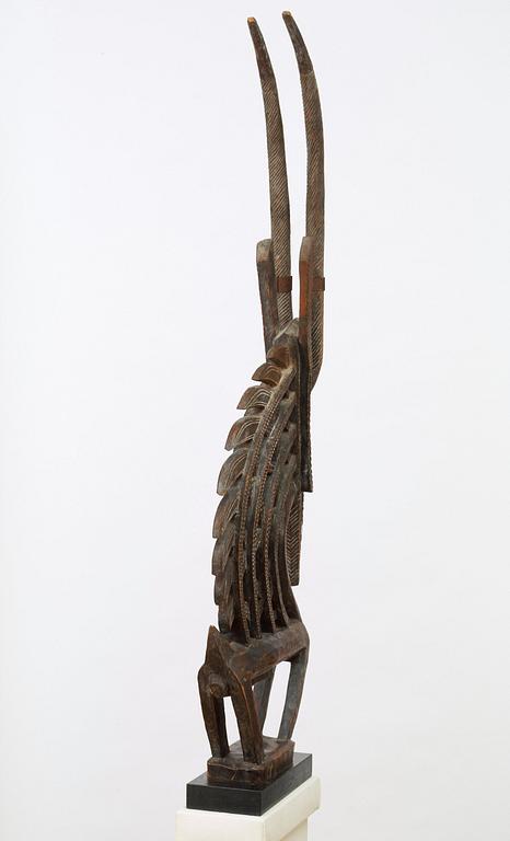 HEADDRESS. Tshiwara/Ciwara (stylized male antelope). Wooden sculpture with metal fittings.