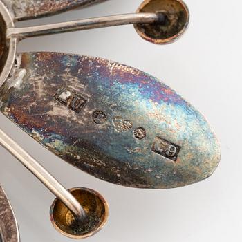Two brooches, silver, one by Rey Urban, flower-shaped.