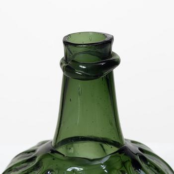 A green twisted glass bottle, 18th century.