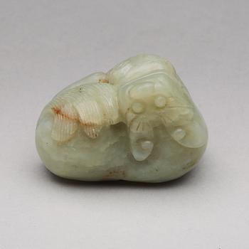 A nephrite figure of a reclining mythical beast, late Qing dynasty.