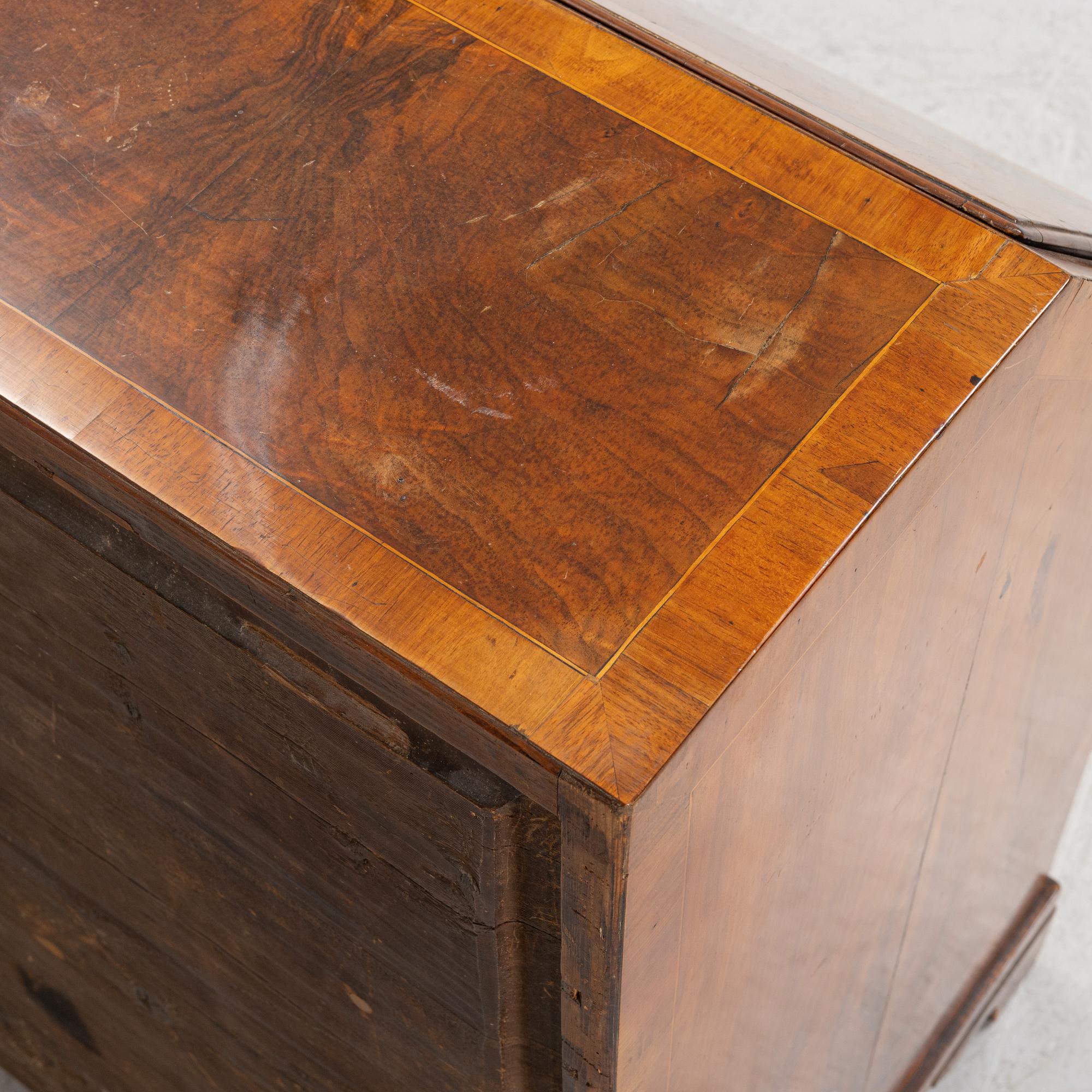 A rococo walnut-veneered and gilt-brass mounted secretaire, later part of the 18th century.