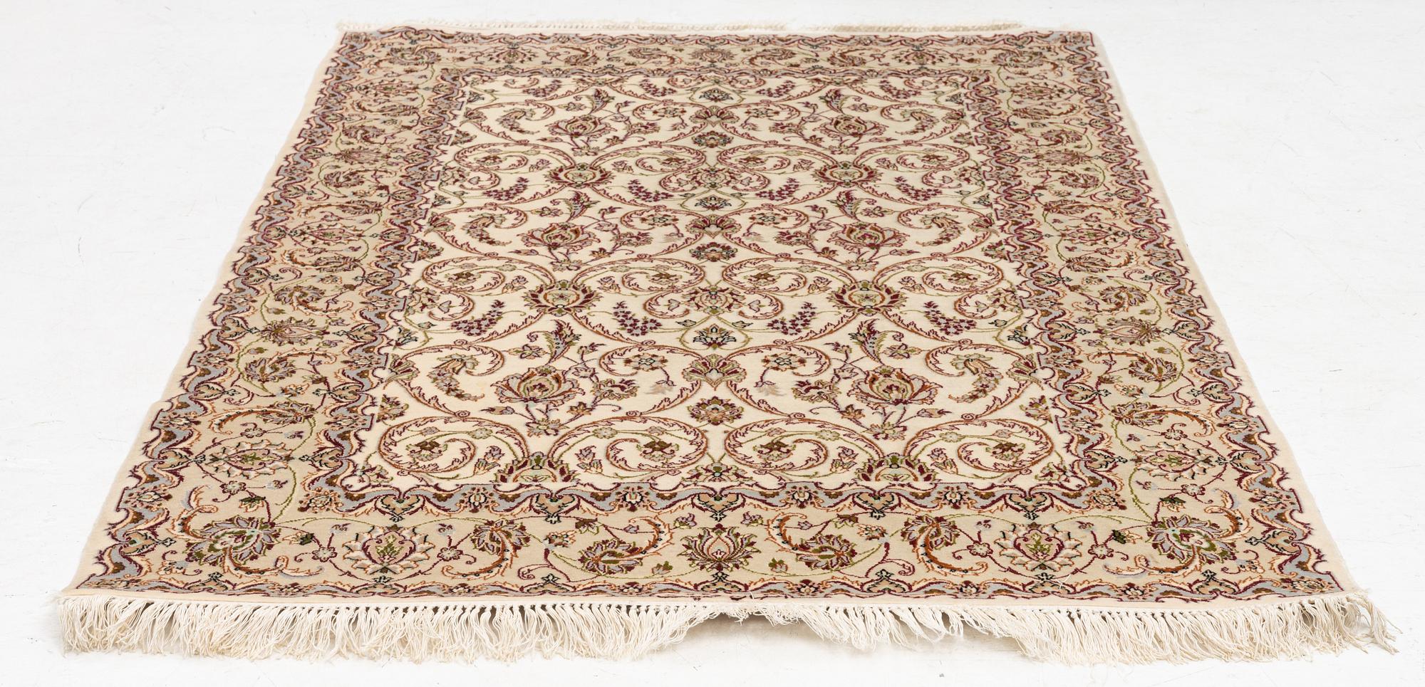 An Isfahan, part silk rug, signed, c. 165 x 112 cm.