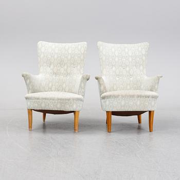 A pair of easy chairs by Carl Malmsten second half of the 20th Century.