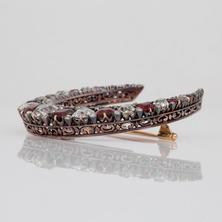 A Victorian spinel and old-cut diamond crescent brooch. Rubies circa 8.50 cts and diamonds circa 10.00 cts in total.