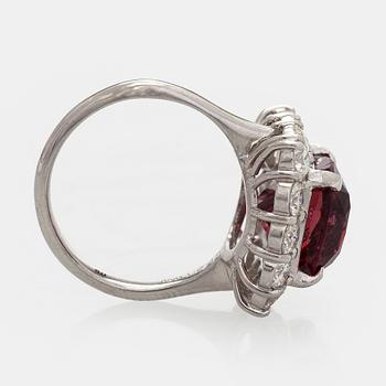 A platinum ring with spinel and brilliant cut diamonds.