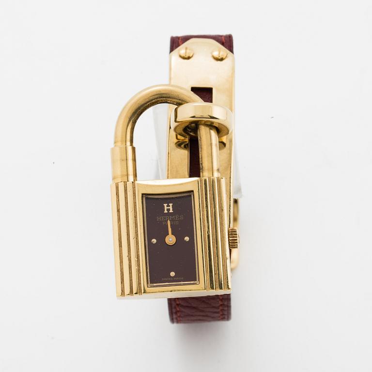 Hermès, a burgundy red leather bracelet with 14k gold plated watch, "Kelly Lock".