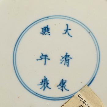 A set of four blue and white dinner plates, Qing dynasty, with Kangxi six character mark and period (1662-1722).