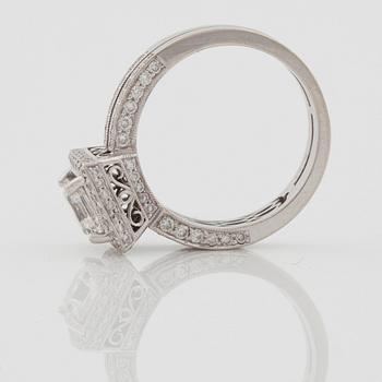 A 1.04 ct Assher cut diamond, quality F/VS1, ring. Shan with pavé set brilliant cut diamonds.