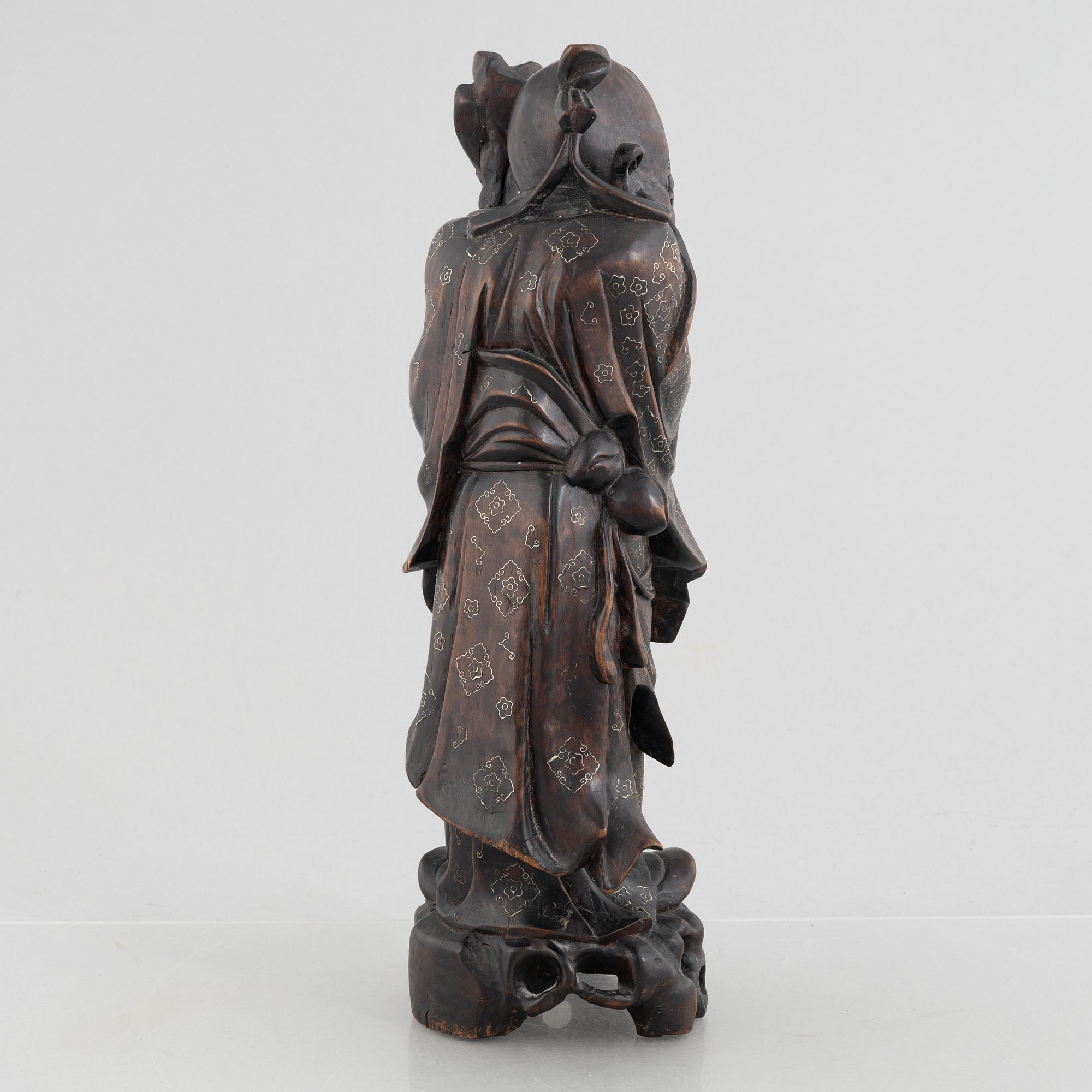 A Chinese wooden figure of 'Shoulao' with silver inlays, 20th century.