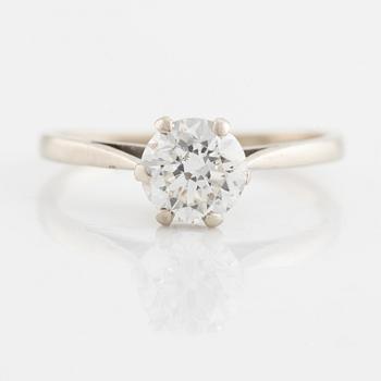 A 14K gold ring set with a round brilliant-cut diamond.