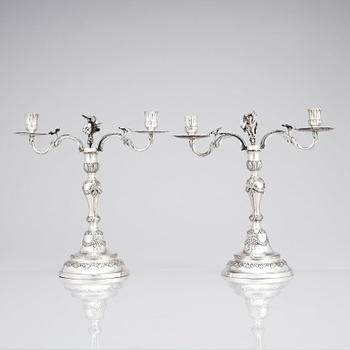 A pair of Swedish 18 century silver candelabras, mark of Lars Åkerblom Gävle 1775, arms by Christian Kullberg.