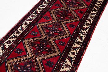 An oriental runner, c. 395 x 100 cm.