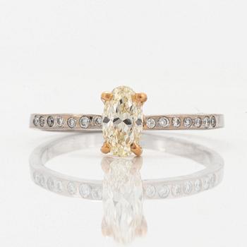 Oval diamond and brilliant-cut diamond ring.