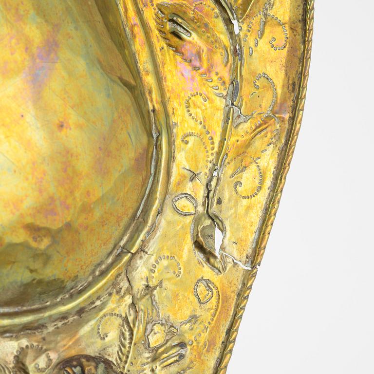 A pair of Baroque repoussé brass one-light sconces, first part of the 18th Century.