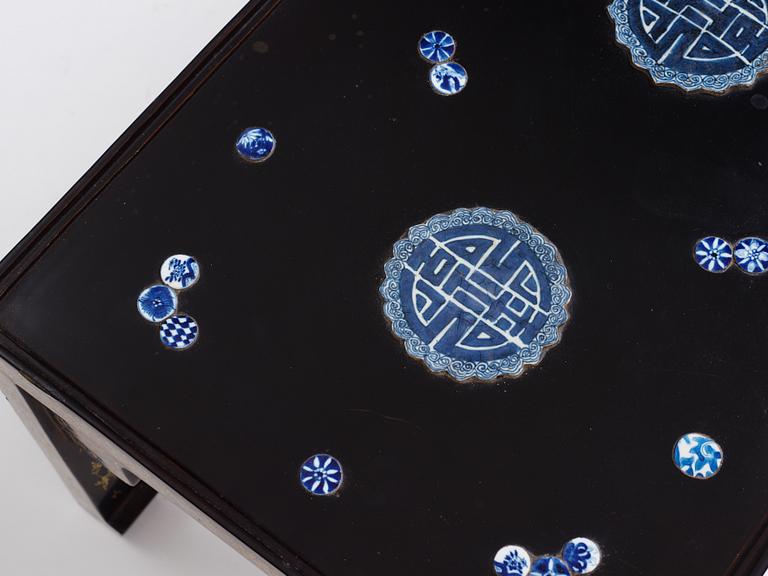 A Chinese black lacquered table with porcelain placques, presumably first half of the 20th century.