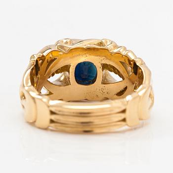 An 18K gold ring with a sapphire.