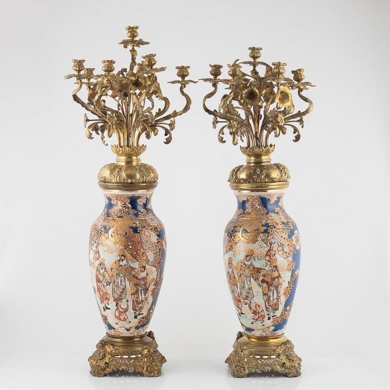 A pair of gilt-brass and satsuma ware seven-light candelabra, the porcelain Meiji period (1868-1912).