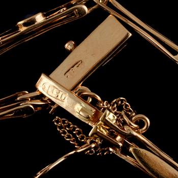 ARMLÄNK, 18k guld, 2 fasettslipade blå safirer samt äldre briljantslipad diamant. Vikt 8 g.