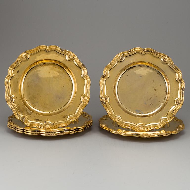 A German set of twelve 19th century silver-gilt plates, mark of Hossauer, Berlin. Rokoko-style.