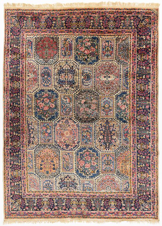 An carpet, possibly Kirman, signed, 350 x 255 cm.