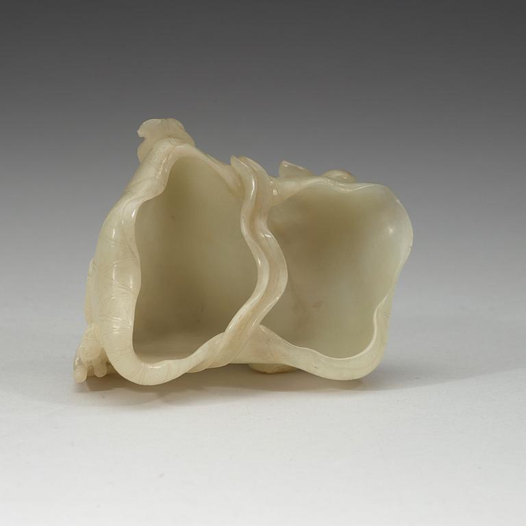 A nephrite brush washer, on a hardwood stand with silver inlay, Qing dynasty (1644-1912).