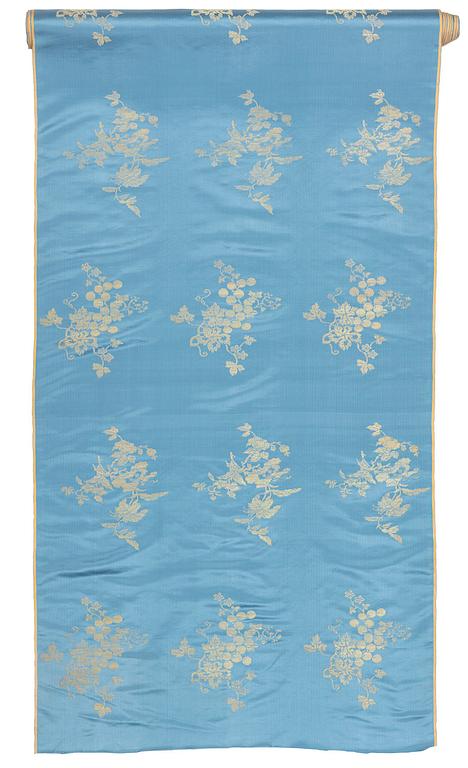 A bolt of Chinese pale blue and gold silk fabric, early 20th century.