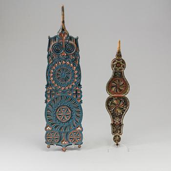 Two painted folk art flax ornaments dated 1817 and 1853.