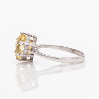 An 18K white gold ring with an oval faceted sapphire.