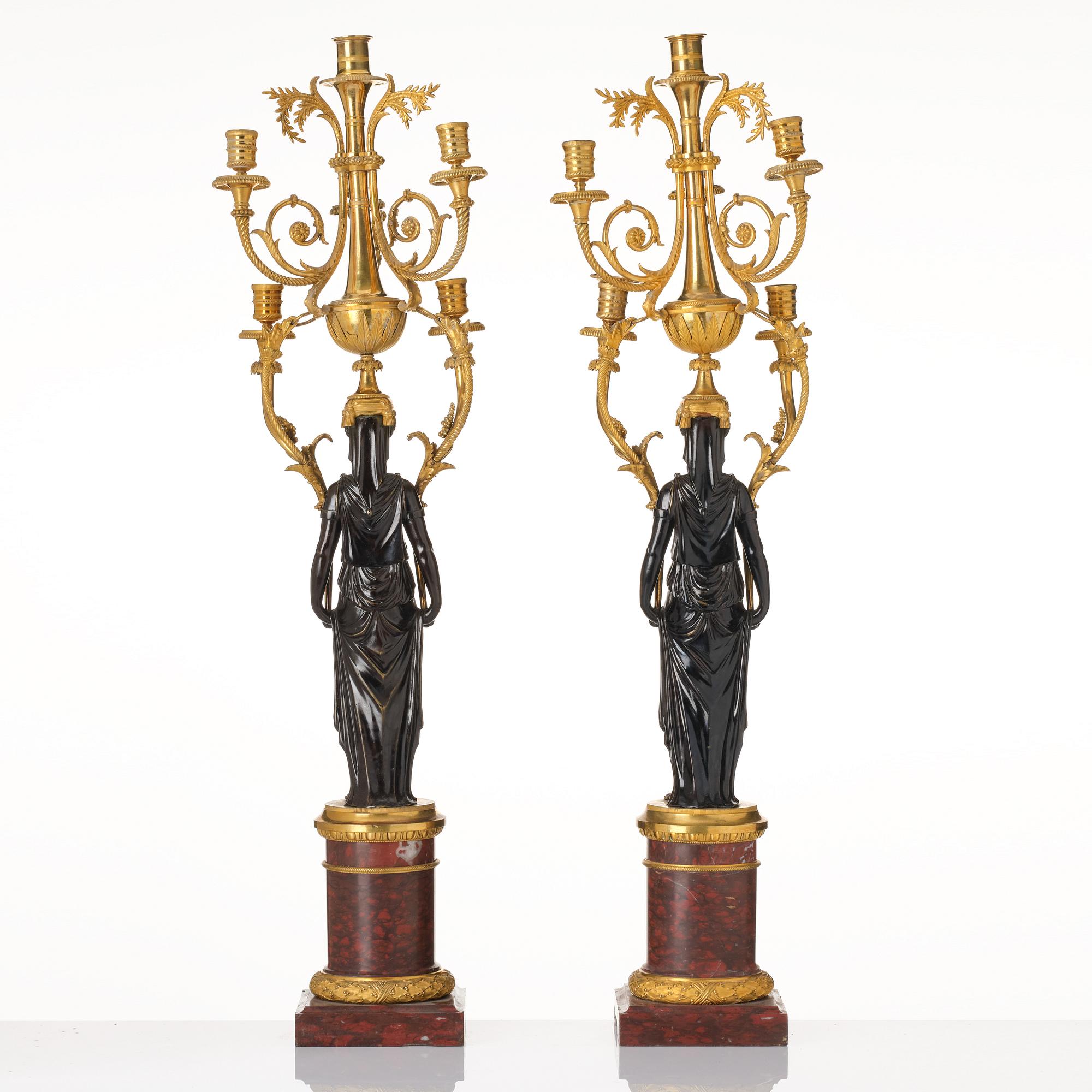 A pair of Louis XVI ormolu and patinated bronze six-branch candelabra attributed to François Rémond, late 18th century.