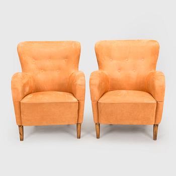 A pair of mid-20th century armchairs.
