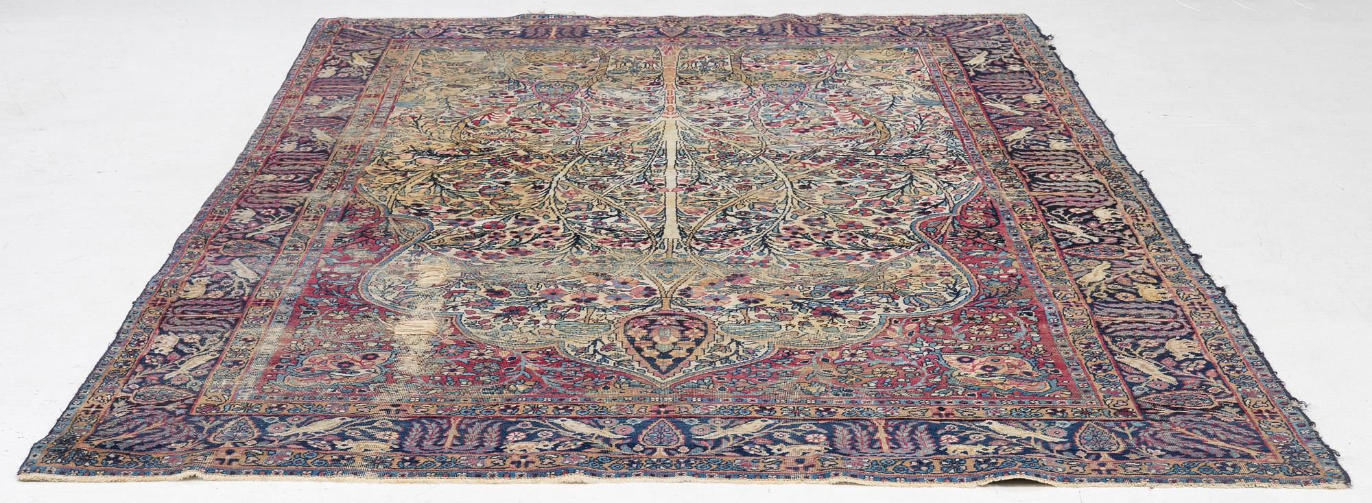A semi-antique Kerman carpet, c. 325 x 203 cm.