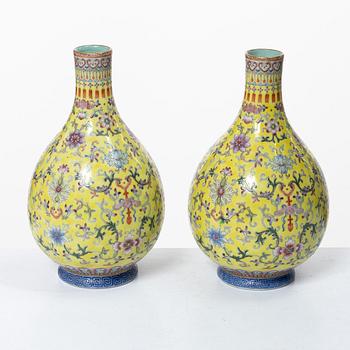 A pair of Chinese yellow ground porcelain vases, 1900s.