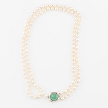 Pearl necklace, two pieces, cultured pearls, one with a clasp, Carlman, 18K white gold with cabochon-cut emerald and diamonds.