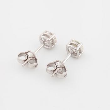 A pair of brilliant cut diamond earrings.
