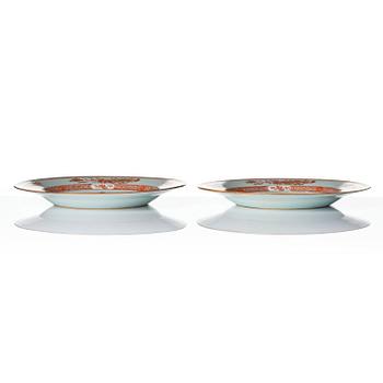 A pair of iron red decorated armorial dishes, Qing dynasty, 18th century.