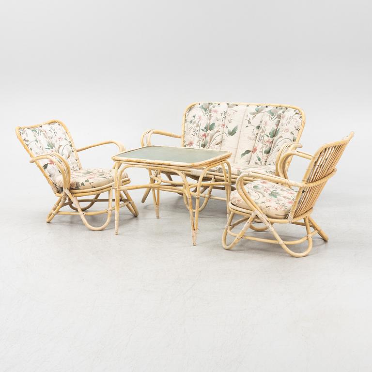A rattan sofa, table and a pair of armchairs, second part of the 20th Century.