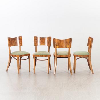 A set of four mid 20th century chairs in walnut.