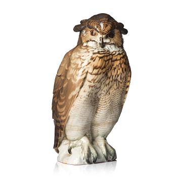 102. Waldemar Lindström, a glazed porcelain sculpture of an Eurasian Eagle-Owl, Rörstrand, early 20th century.