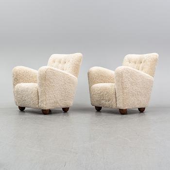 A pair of 1940's lounge chair with later sheepskin upholstery.