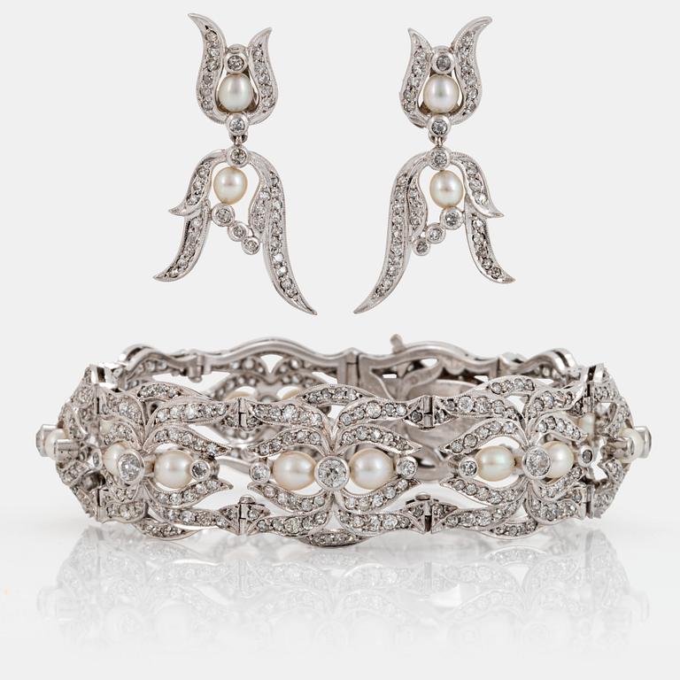 A platinum bracelet and a pair of earrings set with pearls and old-, eight- and rose-cut diamonds.