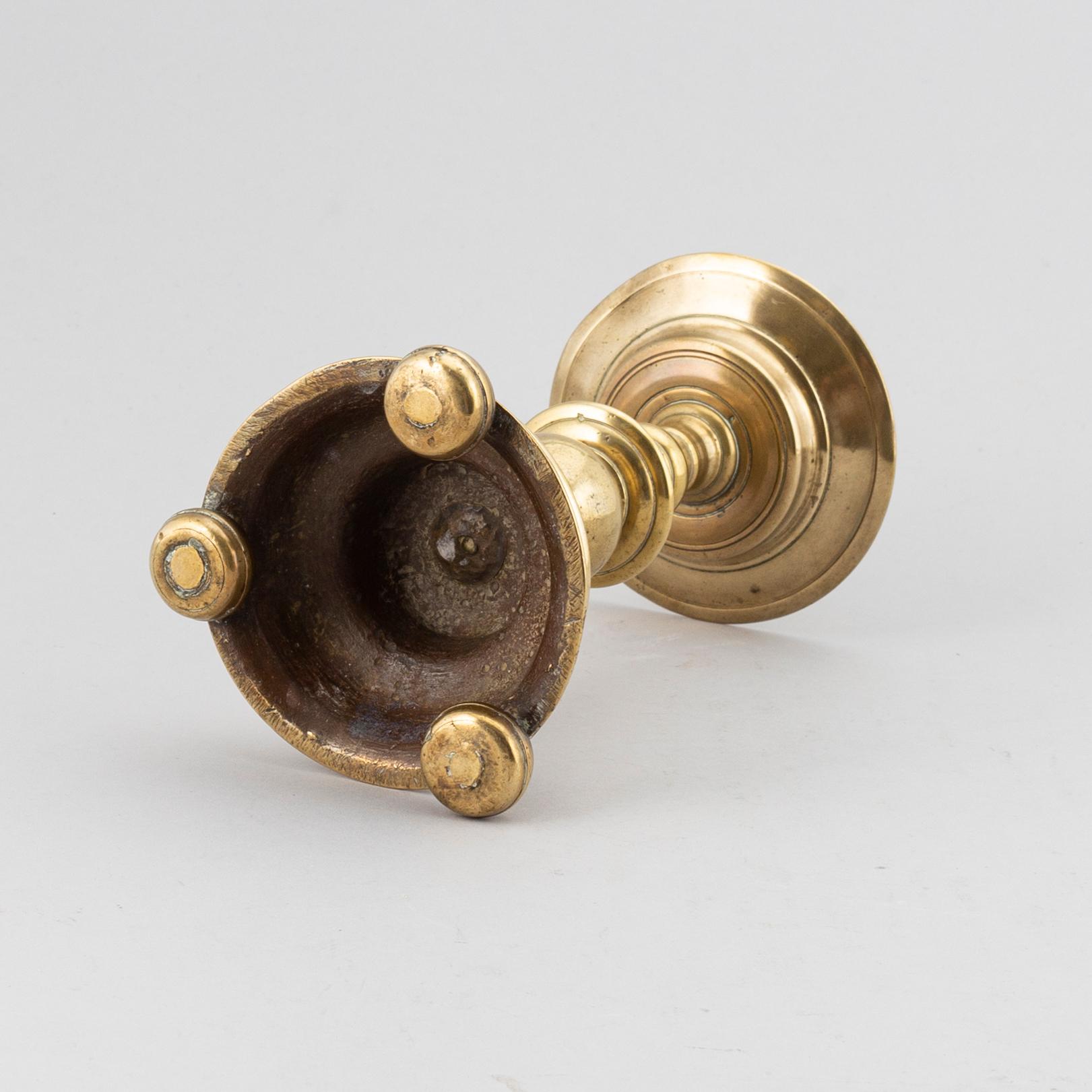 A 16th century bronze candlestick.