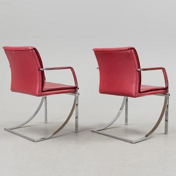 A pair of crome and leather 1970/80s armchairs.
