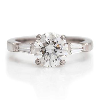 A platinum ring with a brilliant cut diamond ca 1.80 ct and two side-diamonds totalling ca 0.10 ct. With certificate.