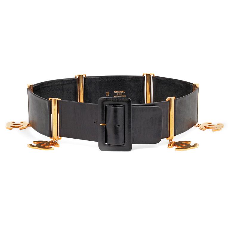 CHANEL, a black leather belt with golden logo charms.