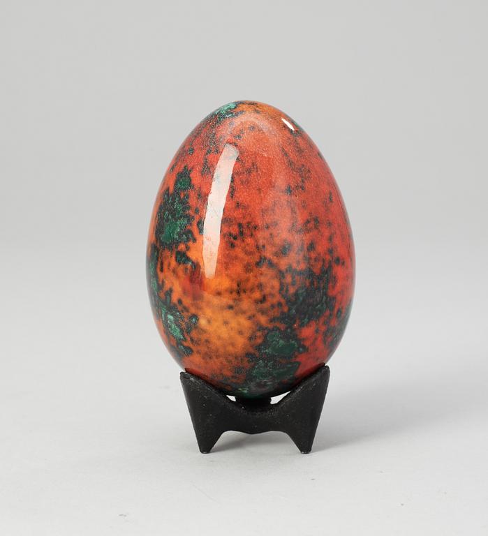 A Hans Hedberg faience egg on an iron base, Biot, France.